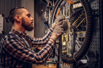 image of person servicing a bike.
